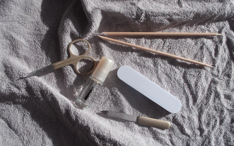 Nail care tools laid out on a soft grey towel